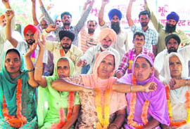 (Above) Farmers stage a protest against the acquisition of their lands; and a piece of fertile land at Panjokhra village. 