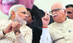 BJP stalwart LK Advani and Gujarat CM Narendra Modi in conversation during his Jan Chetna Yatra at Bharuch in Gujarat on Monday. 