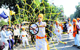 Youngsters perform gatka during a procession on the occasion of Gurpurb celebrations in Chandigarh on Tuesday.