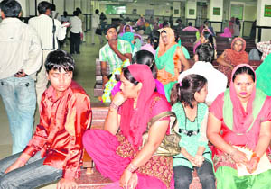 Patients wait for doctors at the Rohtak Civil Hospital on Tuesday. 