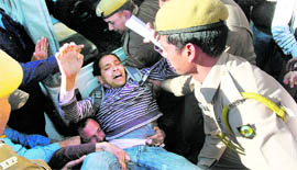 The police carries away a CITU activist during a protest against the petrol price hike at the Mall Road@@in Shimla on Tuesday.