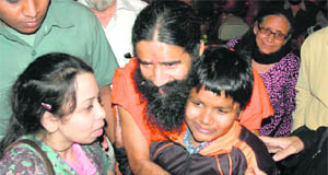 Baba Ramdev interacts with children at the Pingalwara society in Amritsar on Tuesday. 