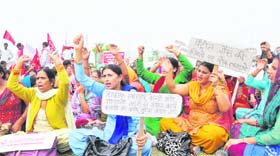 Activists of the Centre of Indian Trade Unions hold a protest in Jammu on Tuesday