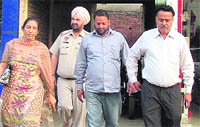 Assistant Town Planner Kamaljit Kaur comes out of a police station