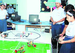Students operate robots at Sat Paul Mittal School in Ludhiana. 