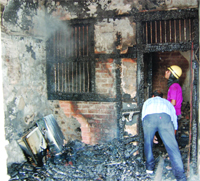 Firemen douse the flames on the second storey of a house at Kathianwala Bazar in Amritsar on Wednesday