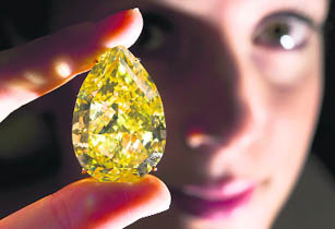 A model poses with the Sun-Drop diamond during a press preview of Sotheby's auction in Geneva on Wednesday