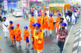 Devotees taking part in a Nagar Kirtan taken out on the eve of the birth anniversary of Guru Nanak Dev Ji in Bathinda on Wednesday. 