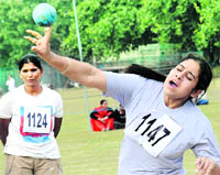 A participant throws a throw-ball during the ongoing athletics meet at Panjab University, Chandigarh