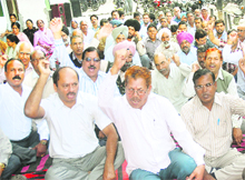 Employees of the Food Corporation of India hold protest demanding pension scheme in Jalandhar on Wednesday.