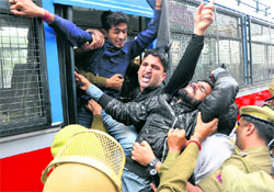 Students being herded into a police vehicle during a protest demonstration to gherao the Assembly in Jammu on Wednesday