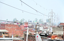 A view of high-tension wires passing over houses at New Kundan Puri in Ludhiana; 