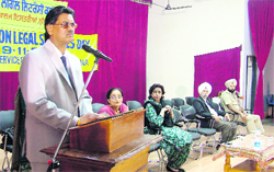 SP Bangarh, chairman of District Legal Services Authority-cum-Sessions Judge, addresses a seminar in Ludhiana on Wednesday.