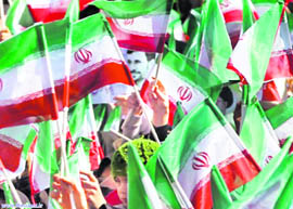 Supporters of Iranian President Mahmoud Ahmadinejad wave flags during his speech in Shahrekord in Chahar Mahal and Bakhtiari province
