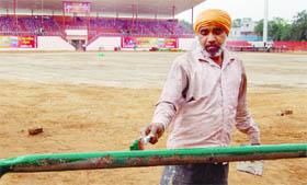 A worker gives finishing touches to Guru Nanak Dev Stadium in Amritsar on Thursday.