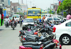 Vehicles parked on the pavement and the road near the HDFC Bank and the State Bank of India in Bathinda on Thursday