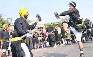 Sikh devotees perform gatka during the Nagar Kirtan on Gurpurb in Faridabad on Thursday