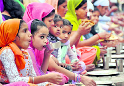 Devotees partake of langar on Gurpurb at a gurdwara in Ludhiana on Thursday