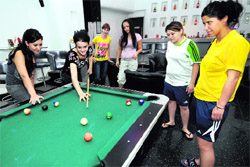 Kabaddi players from Turkmenistan play billiards at a hotel in Ludhiana on Thursday