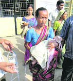 A woman carries her grandson infected with malaria at Malda district hospital 