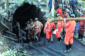 Rescue workers descend into the coal mine where a leak killed 20 miners and trapped another 23 in southwest Chinas Yunnan province on Thursday