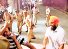 A TV grab of the attacker (L) of BKI terrorist Jagtar Singh Hawara (R) being taken into custody in Chandigarh on Friday