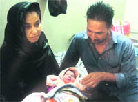 Jang Singh and Daljit Kaur with their newly born daughter in a maternity hospital in Jagraon