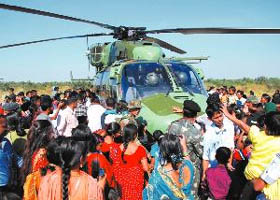 A curious crowd gathers around an Army helicopter to have a closer look. 