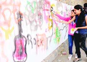 Girls participate in a wall competition at PEC Fest in Chandigarh on Saturday