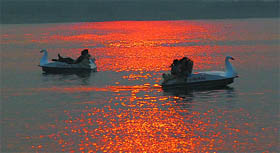 The setting sun leaves a shimmering glow at the thermal lake in Bathinda.