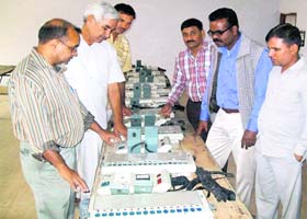 Officials inspect electronic voting machines in Ratia on Sunday