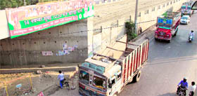 A hoarding atop an under construction bridge at Chogatti chowk in Jalandhar on Sunday. 