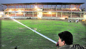 A fireman waters the ground of Guru Gobind Singh Stadium ahead of a World Kabaddi Cup match on November 16 in Jalandhar.