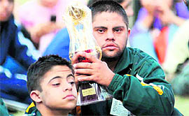 The winners of the Special Olympics pose with their trophy in Ludhiana on Sunday.