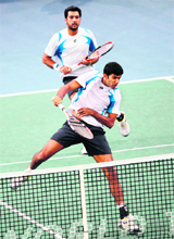 Pakistans Aisam-Ui-Haq Qureshi (top) and Indias Rohan Bopanna in action during their double final of the Paris Masters on Sunday. 