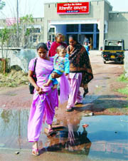 Patients and their kin had to cross through sewer water to come out of a satellite hospital in Kala villege.