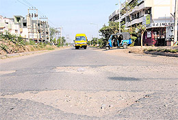 A potholed road has not been repaired for years in Sector 50.