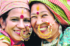 Two women wearing traditional nose rings at the mela.