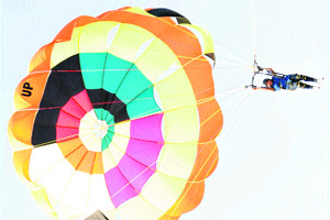 A para-sailor displays her skills at an aero-sports show organised to mark Childrens Day at Bachhod village in Mahendragarh district on Monday.