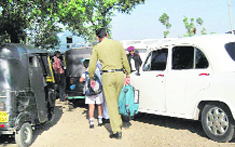  A PSO carrying the schoolbag of a child of his escortee.