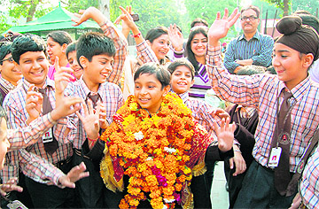 Winner of the National Children Award for Exceptional Achievement Agam Shinghari gets a warm welcome from his classmates at DAV Public School in Amritsar on Tuesday. Photo: Vishal Kumar