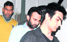 The accused, Abir Malhotra (right), at the police headquarters in Sector 9, Chandigarh, on Tuesday. Vinod Kumar (left), who also made up a ~90,000-robbery, also in police custody.