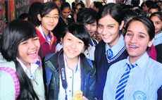 Students from Singapore pose with their local peers at Government Model Senior Secondary School in Sector 35 of Chandigarh on Tuesday. 