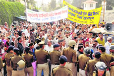 Fourth Class employees of the state hold a protest march in Dehradun on Tuesday.