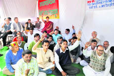 Members of the Uttarakhand Bhrashtachar Virodhi Morcha stage a dharna in Dehradun on Tuesday.