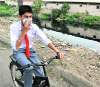 A schoolboy finds it tough passing the Budda Nullah area in Ludhiana