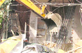 A structure being pulled down near Maharaja Nagar in Ludhiana on Tuesday.