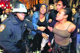 Members of the Occupy Wall Street movement clash with the police after being removed from Zuccotti Park in New York on Tuesday