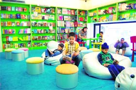 Loving written word: Children spend a relaxed time with their books at a library in Amritsar