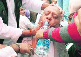 Former Deputy Chief Minister Mangat Ram Sharma, who fainted during the Martyrs Day function in Jammu on Wednesday, being offered water